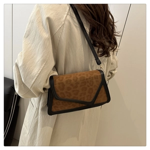 Detail of leopard print shoulder bag with black trim and sleek leather strap styling