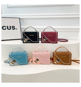 Five assorted crossbody chain bags in matte suede displayed on a white tiered stand