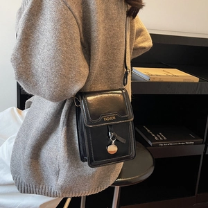 Fashionable black glossy crossbody phone bag with gold metal charm for women