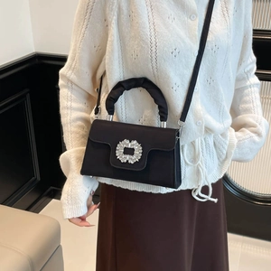 Elegant black satin crossbody bag with sparkling rhinestone buckle and ruffled handle