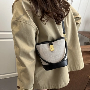 Retro contrast bucket bag in beige canvas and black leather with gold clasp