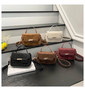 Detail view of five assorted stylish crossbody bags with metallic locks on steps