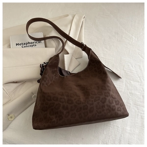 Detailed view of dark brown leopard print hobo bag with smooth leather shoulder strap