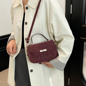 Burgundy faux leather crossbody bag with leopard texture and gold twist lock closure