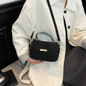 Classic black Kelly bag with leopard texture, golden twist lock and leather strap