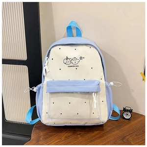Detail of blue and beige school backpack with cartoon animal prints and clear PVC pocket
