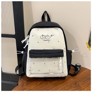 Detail of cute polka dot backpack with clear front pocket and cartoon dog print