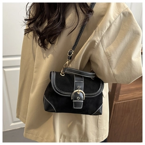Detail of black vintage crossbody bag showing contrast stitching and gold buckle