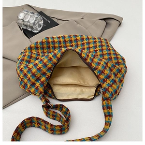 Detailed interior view of multi-color houndstooth tote bag with zipper and lining
