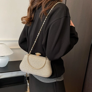 Fashionable champagne glitter chain bag with jewel clasp worn over the shoulder