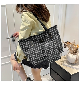 Lifestyle shot of large geometric chain print tote bag with matching inner pouch and gold rivets