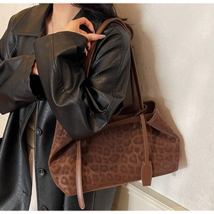 Detail of leopard print tote bag with suede texture and slim leather shoulder straps