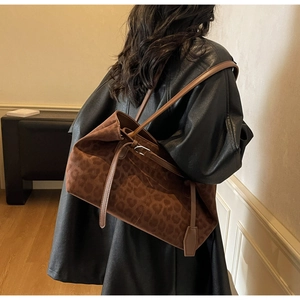 Brown leopard print tote bag in soft suede-like texture styled for shoulder wear