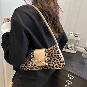 Leopard print underarm shoulder bag with bow detail and sleek patent leather strap