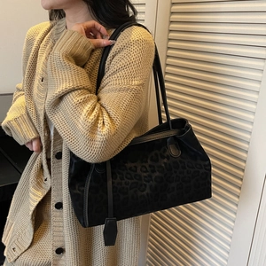 Retro black leopard print tote bag for women worn by a model in a casual setting