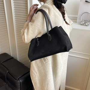 Minimalist black matte tote bag with long shoulder straps for high-capacity daily commute