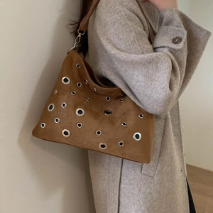Brown suede shoulder bag with silver rivet studs and a wide strap for a vintage look