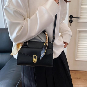 Elegant black PU leather handbag with gold twist lock and vintage scarf on handle