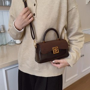 Retro dark brown patchwork leather handbag with a gold S-shaped lock and slim strap