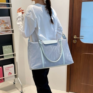 Light blue large capacity waterproof travel bag with wrinkled nylon fabric and shoulder strap