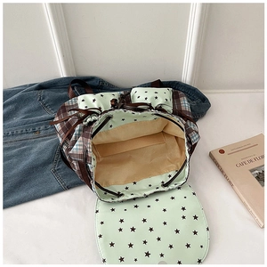 Detail view of the star pattern drawstring backpack showing interior pocket and lining