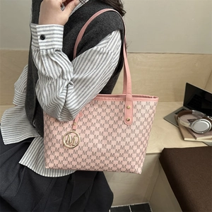 Pink tote bag with M-letter pattern and gold hardware shown in a daily lifestyle scene