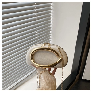 White lychee texture acrylic evening clutch with chunky gold handle and chain strap