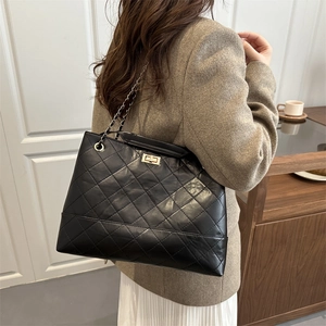 Classic black quilted leather tote bag with gold chain strap and turn-lock closure