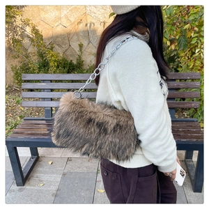 Detail of plush faux fur shoulder bag with silver chain strap and brown animal print