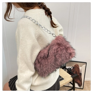 Detail of plush faux fur shoulder bag with silver chain strap shown on a model