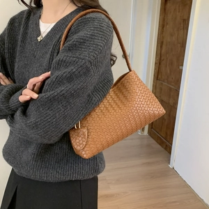 Minimalist caramel brown woven leather underarm bag for women with wide shoulder strap