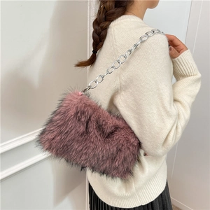 Chic mauve faux fur shoulder bag with silver chain strap shown on model's shoulder