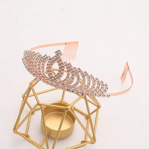 Detail of rose gold bridal tiara with sparkling rhinestones and securing hair combs