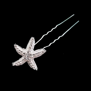 Macro detail of starfish hair pin with shimmering white rhinestones and silver-plated alloy