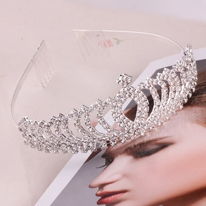 Detail of silver bridal crown with sparkling rhinestones and integrated hair combs