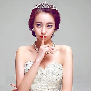 Elegant bridal tiara set with crystal headband and pearl necklace shown on bride