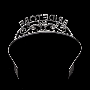 Macro shot of silver Bride To Be tiara with sparkling rhinestones on black background
