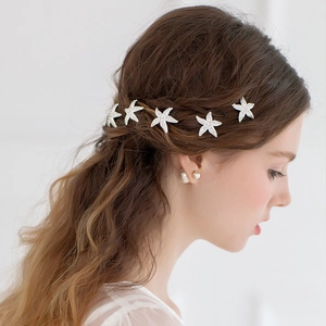 Five-piece bridal starfish hair pins set with rhinestones on an elegant model
