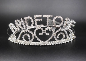 Macro detail of silver bride to be tiara with sparkling rhinestones and heart patterns