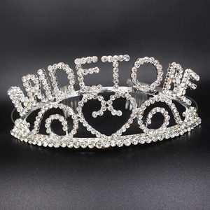 Macro detail of silver Bride to Be tiara with sparkling rhinestones and heart motif