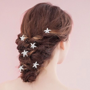 Set of 6 silver starfish hair pins with rhinestones styled in a bridal updo hairstyle