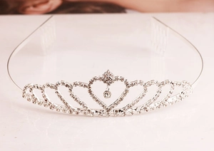 Detailed close-up of a silver rhinestone crown headband with heart-shaped metal alloy frame