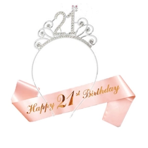 Detail of silver rhinestone crown with number 21 and pink Happy 21st Birthday sash