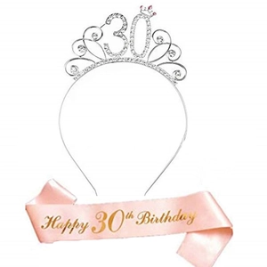 Detail of silver rhinestone 30th birthday tiara and pink satin sash with gold lettering