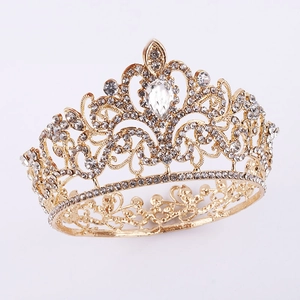 Close-up of golden bridal crown with teardrop crystal and intricate diamond patterns