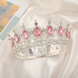 Detail of luxury silver bridal crown with pink water-drop crystals and clear rhinestones