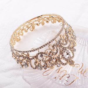Detail of elegant gold bridal crown with shimmering rhinestones and floral patterns
