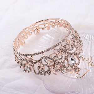 Macro shot of rose gold bridal tiara with sparkling crystal rhinestones and teardrop gem