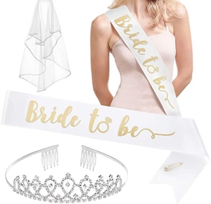 Detail view of bride to be bachelorette party set with sash, veil and rhinestone tiara