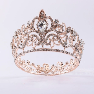 Detail of rose gold bridal crown featuring white rhinestones and large teardrop crystal